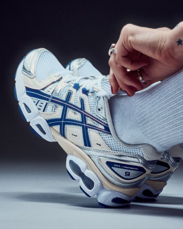 Close-up van de ASICS GEL-Nimbus 9 White Light Indigo 1202A278-108 met ademend mesh, reflecterende details en zachte GEL-demping