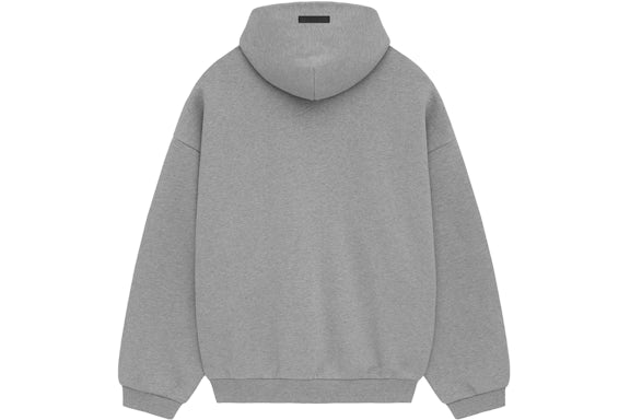 Model wearing Fear of God Essentials FW24 Dark Heather Hoodie highlighting oversized fit, cozy cotton fabric and minimalist streetwear style.