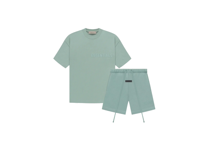 Fear of God Essentials Sycamore Summer Set with short sleeve T-shirt and shorts displayed flat on neutral beige background.