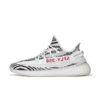 Zijaanzicht van de adidas Yeezy Boost 350 V2 Zebra CP9654 met zwart-wit gestreepte Primeknit upper en rode “SPLY-350” branding