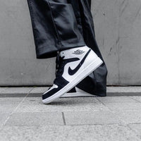 Meerdere Jordan 1 Mid Carbon Fiber sneakers op rij – glanzende afwerking onder studioverlichting, populaire keuze onder jongeren