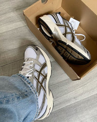 ASICS GEL-1130 White Clay Canyon sneaker unboxing showing white mesh texture, brown accents and retro running design.