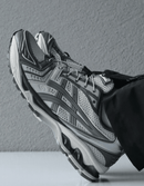 Close-up van de hiel met zichtbare GEL-demping en reflecterende ASICS-branding – stabiel en comfortabel

