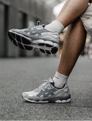 Bovenaanzicht van de ASICS GEL-NYC White Steel Grey – zicht op tong, veters en neutrale paneelstructuur via Snrkickz