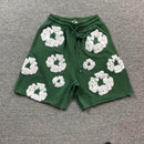 Denim Tears The Cotton Wreath Shorts Green – close-up weergave van borduursel op stevige groene stof