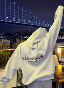 Fear of God Essentials Dark Oatmeal Hoodie – achterkant gedragen bij stedelijke nachtverlichting met oversized fit