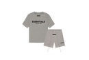 Fear of God Essentials Dark Oatmeal Summer Set with T-shirt and shorts displayed flat on neutral beige background.