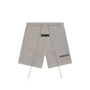 Fear of God Essentials Dark Oatmeal shorts flat lay highlighting minimalist branding, elastic waistband and signature drawcords.