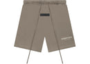Fear of God Essentials Desert Taupe shorts flat lay highlighting relaxed fit, tonal branding and minimalist streetwear design.