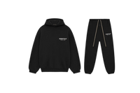 Fear of God Essentials FW24 Black White full set with hoodie and sweatpants displayed flat on neutral studio background.