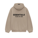 Model wearing Fear of God Essentials FW24 Desert Sand Hoodie styled with neutral pants highlighting oversized fit, cozy fabric and clean streetwear look.