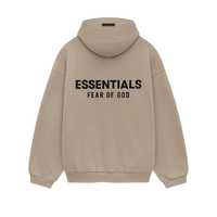 Model wearing Fear of God Essentials FW24 Desert Sand Hoodie styled with neutral pants highlighting oversized fit, cozy fabric and clean streetwear look.