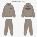 Folded Fear of God Essentials FW24 Heather Taupe set showing relaxed fit, tonal color and premium Essentials embroidery.