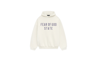 Fear of God Essentials FW24 Shell Hoodie flat lay showing light beige tone, soft cotton fleece and subtle Essentials chest logo.
