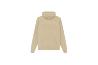 Fear of God Essentials Hoodie Sand flat lay showing light beige tone, soft cotton fleece and minimalist Essentials chest logo.
