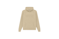 Fear of God Essentials Hoodie Sand flat lay showing light beige tone, soft cotton fleece and minimalist Essentials chest logo.