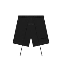 Fear of God Essentials Limo Black shorts flat lay highlighting relaxed fit, tonal logo and minimalist drawstring design.