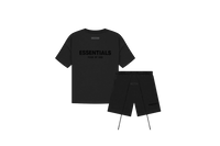 Fear of God Essentials Limo Black Summer Set with short sleeve T-shirt and shorts displayed flat on neutral studio background.