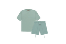 Fear of God Essentials Sycamore Summer Set with short sleeve T-shirt and shorts displayed flat on neutral beige background.
