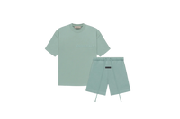 Fear of God Essentials Sycamore Summer Set with short sleeve T-shirt and shorts displayed flat on neutral beige background.