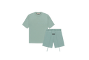 Fear of God Essentials Sycamore Summer Set with short sleeve T-shirt and shorts displayed flat on neutral beige background.