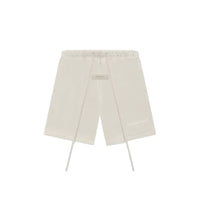 Fear of God Essentials Wheat shorts flat lay featuring minimalist design, elastic waistband and tonal Essentials logo.