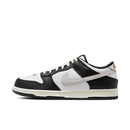 Zijaanzicht van de HUF x Nike SB Dunk Low San Francisco FD8775-001 met zwart leren upper, wit leren toebox en oranje details