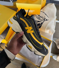 New Balance 1000 Bricks & Wood M1000BD1 in hand met zichtbare suède details, premium mesh en co-branded tong

