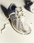 Close-up of New Balance 1906 Moonbeam Raincloud U1906RDD sneaker highlighting laces, stitching and premium mesh texture.