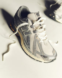 Close-up of New Balance 1906 Moonbeam Raincloud U1906RDD sneaker highlighting laces, stitching and premium mesh texture.