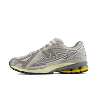 New Balance 1906 Moonbeam Raincloud U1906RDD side view showing silver mesh upper, beige overlays and yellow heel detail.