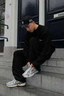 Founder of Snrkickz wearing New Balance Tech explosion white metallic sneakers