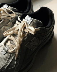 New Balance 1906R x Kith White on-feet met lichte jeans en neutrale outfit styling

