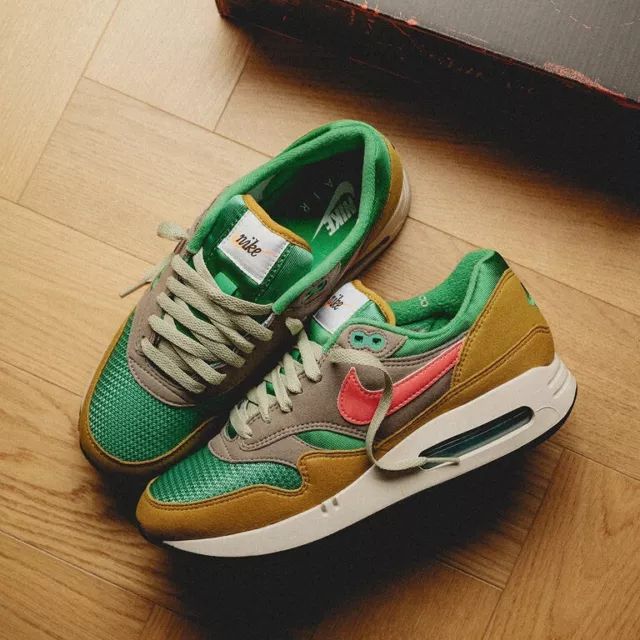 Bovenaanzicht van de Nike Air Max 1 Treeline met mintkleurige veters, grove mesh toebox en klassieke gumzool op houten vloer gefotografeerd