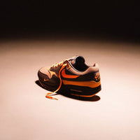 HF7346-200 vastgelegd in zwevende hoek boven warme houten ondergrond, met zicht op de oranje insole en diepbruine mudguard