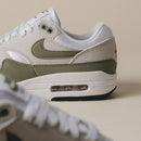 Zijdelingse close-up benadrukt de groene mudguard, witte Swoosh en zichtbare Air-unit in de hiel