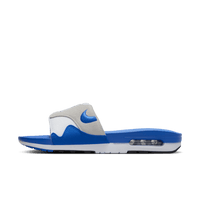 Zijaanzicht van de OG Royal Air Max Slide met transparante Air-unit, witte upper en kobaltblauwe zool op clean white backdrop