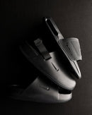 Meerdere paren Nike Air Max Cirro Slide FD4116-003 – stacked display in triple black uitvoering, minimalistisch en clean