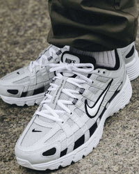 Nike P-6000 Pure Platinum CD6404-006 gedragen met lichte denim in daglicht, glanzende zilvergrijze details en witte accenten zorgen voor een frisse, sportieve look, vastgelegd door Snrkickz.