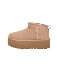 Zijkant van de UGG Classic Ultra Mini Platform in zandkleur, minimalistisch studiobeeld met focus op verhoogde plateauzool