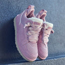 Flatlay van twee Dusty Orchid sneakers op trap gestyled met daglicht vanuit links, veters en sheepskin detail zichtbaar